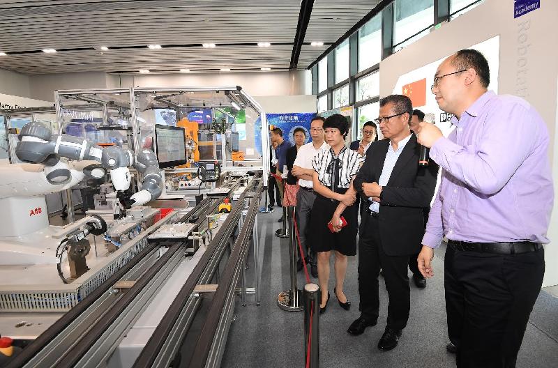 The Financial Secretary, Mr Paul Chan, today (July 30) visited the Robotation Academy Foshan. Photo shows Mr Chan (second right) receiving a briefing from a representative of the Academy.