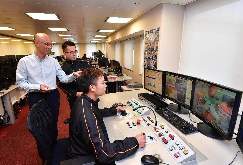 The Secretary for the Environment, Mr Wong Kam-sing (first left), is briefed on the environmental management system of Hongkong International Terminals Limited during his visit to the container terminal today (August 2).
