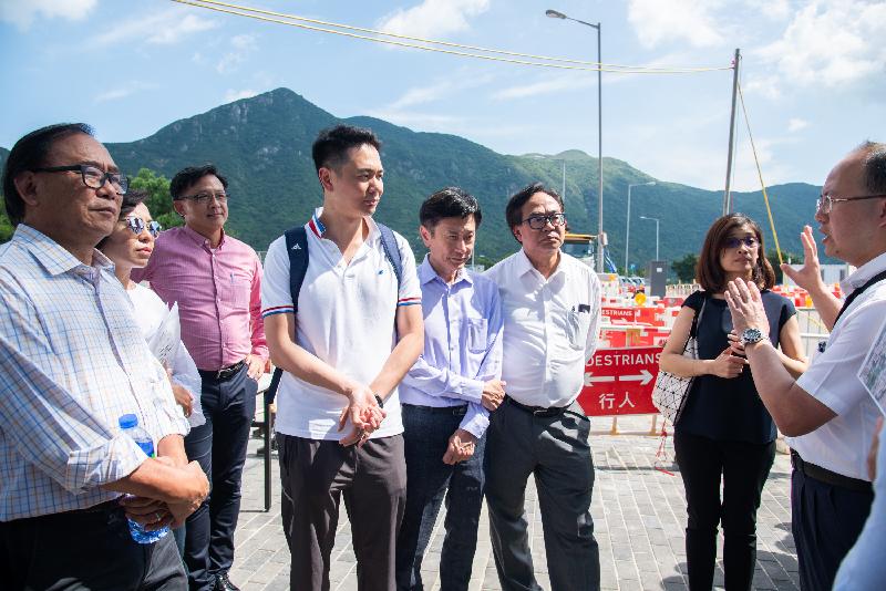 Members of the Legislative Council today (August 8) visited Lantau Island to follow up on a case concerning improvement of the road safety and the traffic network on Lantau Island. Photo shows Members receiving a briefing by a government representative on the district improvement works at Tai O.