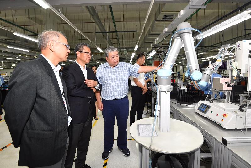 The Financial Secretary, Mr Paul Chan (second left), today (August 9) visits a Hong Kong-invested electronic product company in Dongguan.