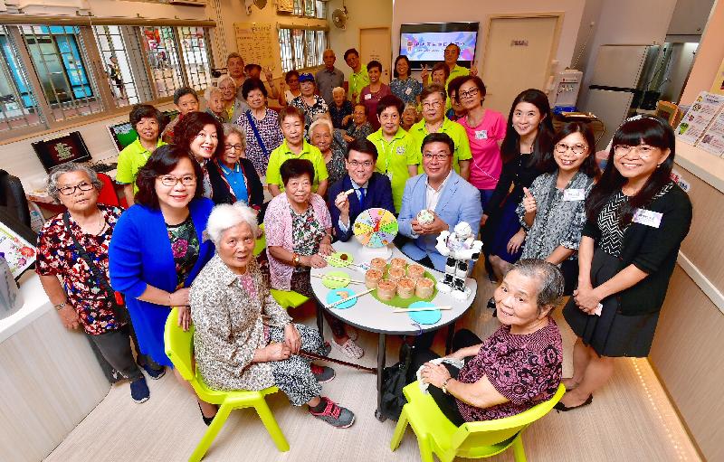 Accompanied by the Chairman of the Wong Tai Sin District Council (WTSDC), Mr Li Tak-hong (second row, fourth right), and the District Officer (Wong Tai Sin), Ms Annie Kong (second row, third right), the Secretary for Commerce and Economic Development, Mr Edward Yau (second row, fifth right), visits the Rhythm Garden Lutheran Centre for the Elderly during his visit to Wong Tai Sin District today (August 10). 