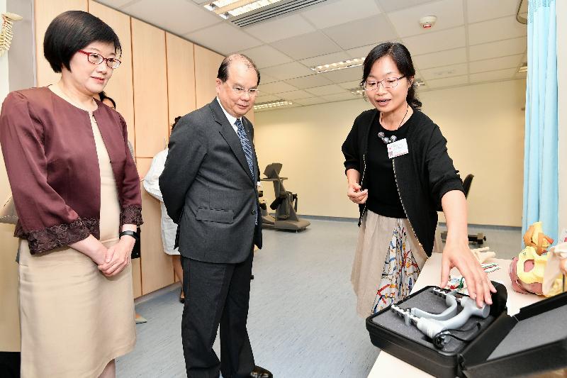 The Chief Secretary for Administration, Mr Matthew Cheung Kin-chung (centre), accompanied by the Director of Health, Dr Constance Chan (left), today (August 14) visits the Wan Chai Elderly Health Centre and is briefed about the physiotherapy service provided by the centre for the elderly.