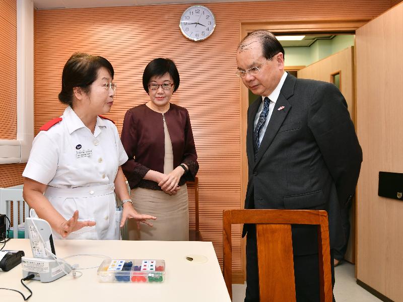 The Chief Secretary for Administration, Mr Matthew Cheung Kin-chung, today (August 14) visited Tang Chi Ngong Maternal and Child Health Centre. Photo shows Mr Cheung (right), accompanied by the Director of Health, Dr Constance Chan (centre), being briefed on the hearing screening service for newborns provided by the centre.