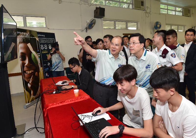 The Chief Secretary for Administration, Mr Matthew Cheung Kin-chung; the Secretary for Security, Mr John Lee; and the Acting Commissioner of Police, Mr Lau Yip-shing; officiated at the Launching Ceremony of the Junior Police Call Fight Crime Summer Camp today (August 15). Photo shows Mr Cheung (second row, left), Mr Lee (second row, right), Mr Lau (third row, third left) and the Acting Chief Superintendent of Police, Police Public Relations Branch, Ms Yu Hoi-kwan (third row, second left) watching the E-sports demonstration after the ceremony.