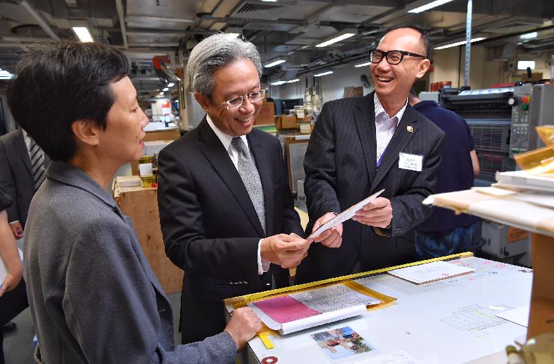 The Secretary for the Civil Service, Mr Joshua Law, visited the Government Logistics Department today (August 20) and toured the Printing Unit of the Printing Division. Photo shows Mr Law (centre) learning about the quality of an invitation card produced by a 5-colour offset printing machine. Looking on is the Director of Government Logistics, Miss Mary Chow (left).
