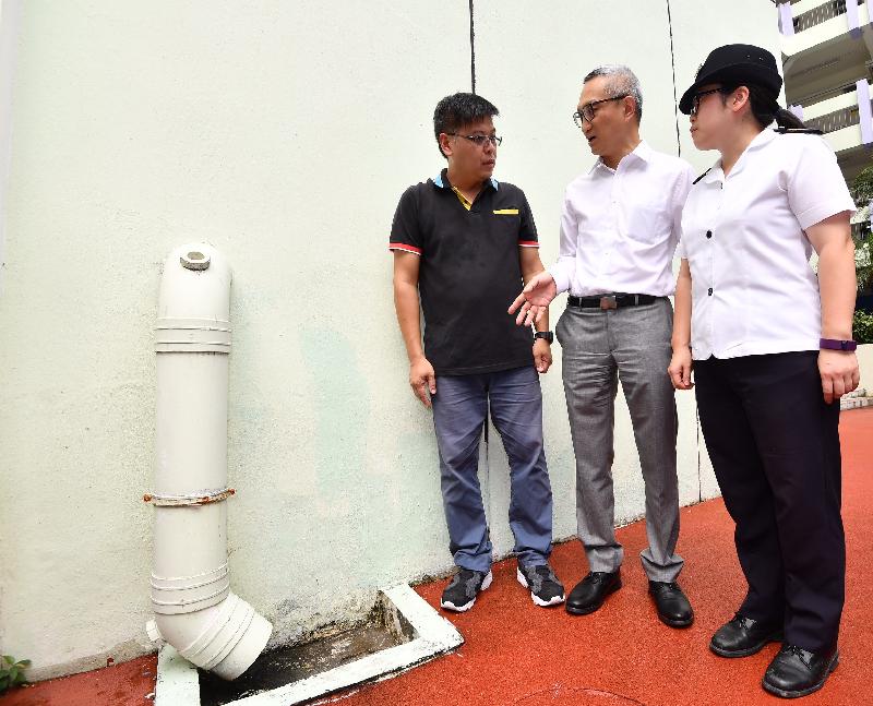 The Acting Secretary for Food and Health, Dr Chui Tak-yi (centre), visited a school in Wong Tai Sin today (August 24) to see the mosquito preventive work in the school premises before the start of the new school year. Photo shows Food and Environmental Hygiene Department staff reminding the school staff to keep all drains free from blockage.