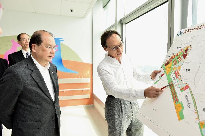 The Chief Secretary for Administration, Mr Matthew Cheung Kin-chung, today (August 24) visited Kowloon City District. Photo shows Mr Cheung (front row, left) receiving a briefing from an officer of the Civil Engineering and Development Department on the latest developments of the Kai Tak Development area.