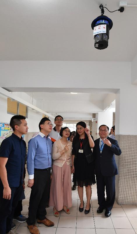 The Secretary for Food and Health, Professor Sophia Chan, today (September 4) visited a primary school in Wong Tai Sin to learn about the measures taken by the school to tackle dengue fever in the new school year. Photo shows the Headmistress of Price Memorial Catholic Primary School, Ms Chan Pik-ki (second right), briefing Professor Chan (third right), Legislative Council member Mr Wilson Or (second left) and the Chairman of the Food and Environmental Hygiene Committee of the Wong Tai Sin District Council, Mr Ho Hon-man (third left), on a mosquito trapping device installed in the school.