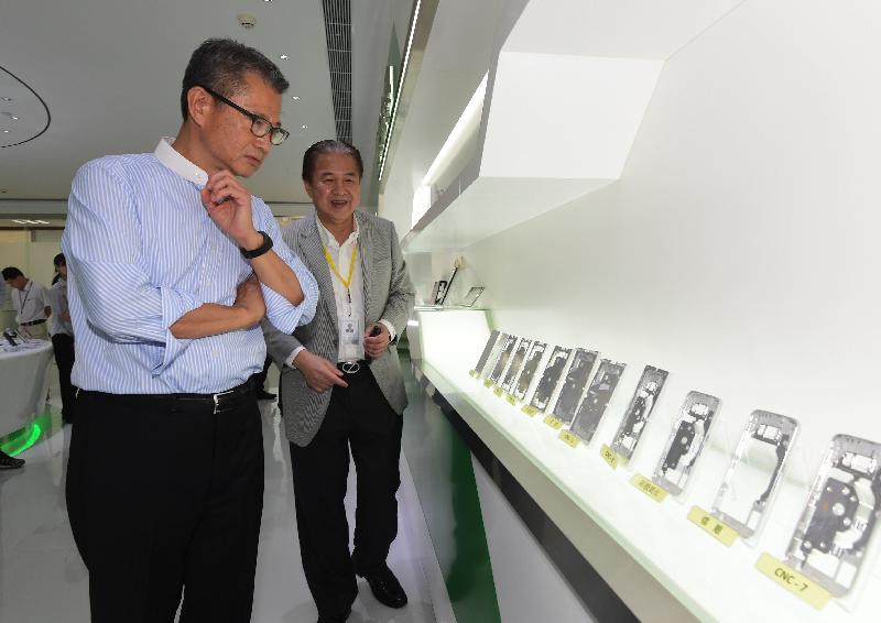 財政司司長陳茂波（左）今日（九月十三日）在惠州參觀一間專營手機和手錶面板生產的港資企業，了解公司在研發新技術和推動先進製造業發展的經驗。