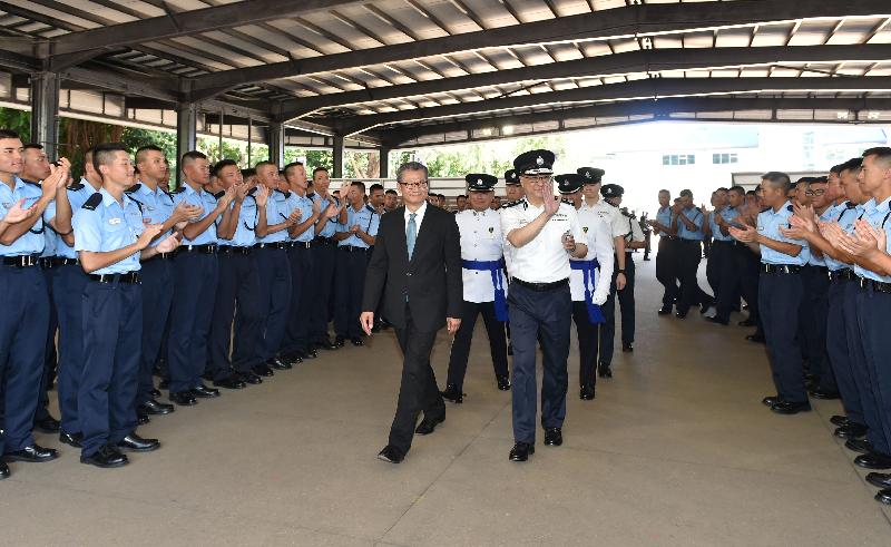 The Financial Secretary, Mr Paul Chan (left), accompanied by the Commissioner of Police, Mr Lo Wai-chung (right), meets graduates after the passing-out parade held at the Hong Kong Police College today (September 15).