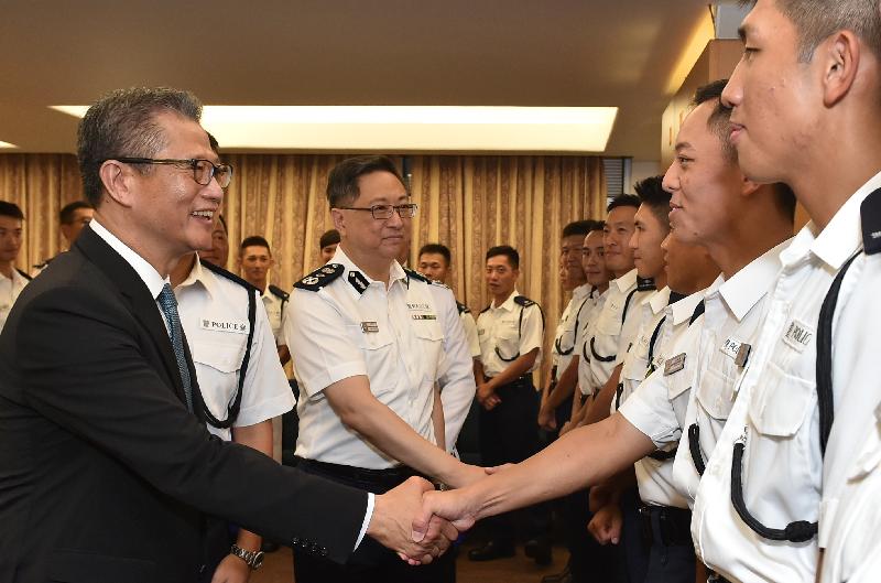 The Financial Secretary, Mr Paul Chan (first left), and the Commissioner of Police, Mr Lo Wai-chung (second left) congratulates the probationary inspectors after the passing-out parade held at the Hong Kong Police College today (September 15).