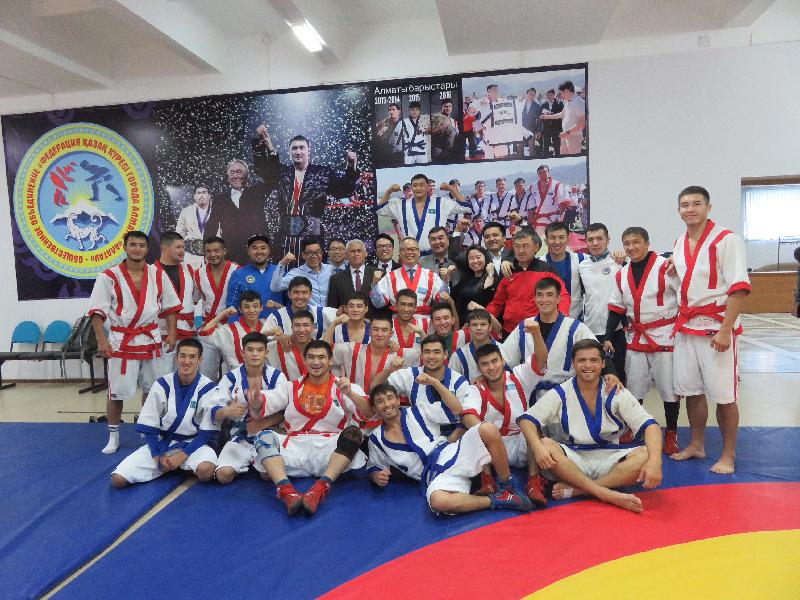 The Secretary for Home Affairs, Mr Lau Kong-wah, today (September 15) continued his trip in Almaty, Kazakhstan. Photo shows Mr Lau (seventh left in front standing row) taking a group photo with athletes after watching a training session of traditional sport event Kazakh kuresi.