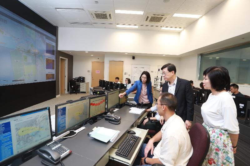 The Secretary for Security, Mr John Lee (second right), this afternoon (September 15) visits the Emergency Monitoring and Support Centre upon its activation and he is briefed, together with the Permanent Secretary for Security, Mrs Marion Lai (first right), on the measures in place to cope with Super Typhoon Mangkhut.