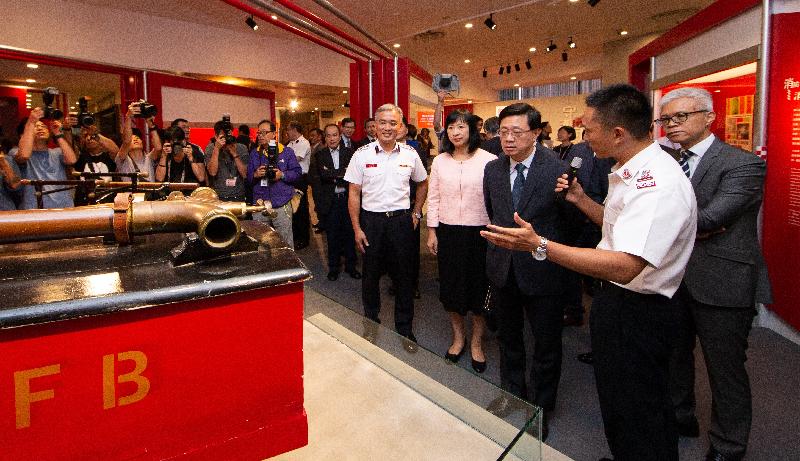 The Secretary for Security, Mr John Lee, officiated at the opening ceremony of "Through Thick and Thin: 150 Years of the Hong Kong Fire Services" exhibition today (September 18). Photo shows Mr Lee (third right), the Director of Fire Services, Mr Li Kin-yat (fifth right), and the Director of Leisure and Cultural Services, Ms Michelle Li (fourth right), briefed by a fire officer at the exhibition.
