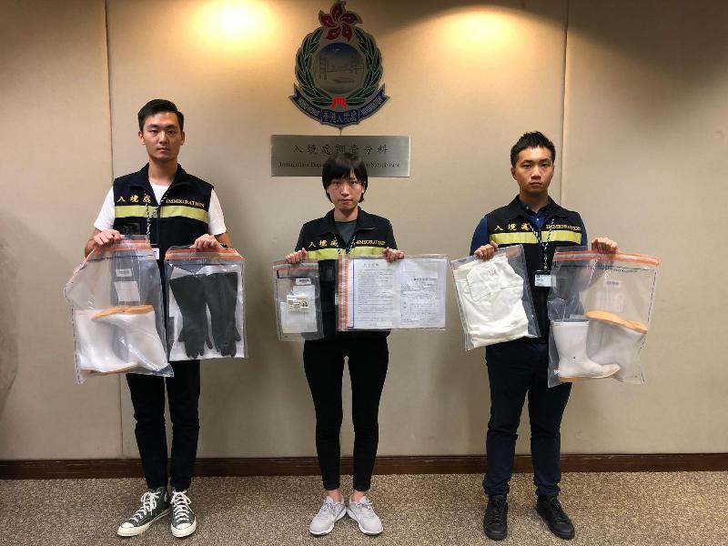 The Immigration Department mounted a territory-wide anti-illegal worker operation codenamed "Twilight" from September 18 to 20. Photo shows officers holding items seized during the operation.
