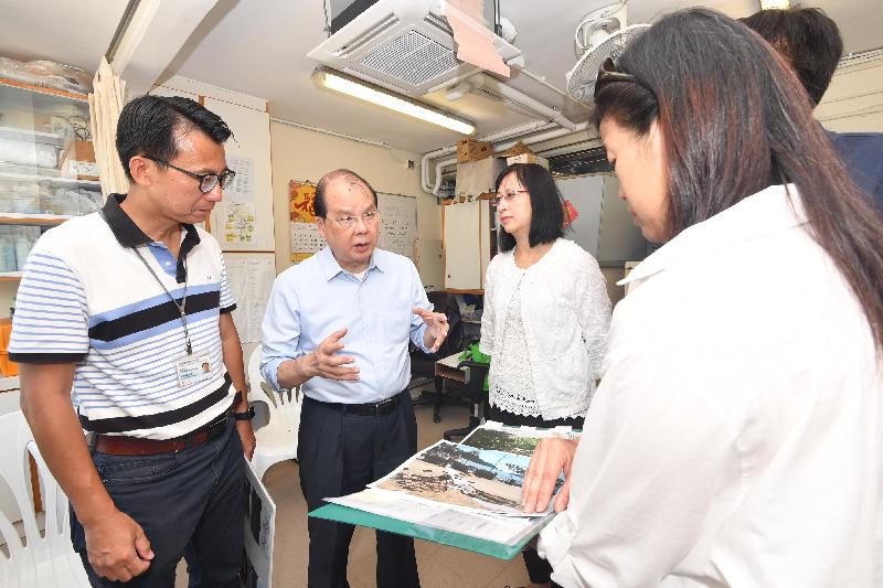 The Chief Secretary for Administration, Mr Matthew Cheung Kin-chung (second left), today (September 25) , accompanied by the Director of Leisure and Cultural Services, Ms Michelle Li (third left), is briefed on the damages brought about by the Super Typhoon Mangkhut and the repair work required at the office of St. Stephen's Beach in Stanley.