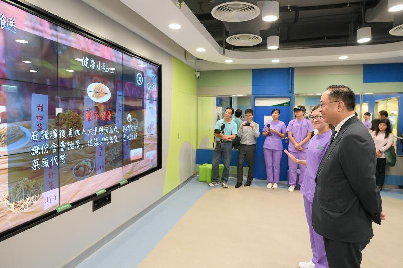 创新及科技局局长杨伟雄（右）今日（十月五日）在香港专业教育学院（葵涌）的健康科技中心，听取学生介绍为长者而设的虚拟实境体感游戏。