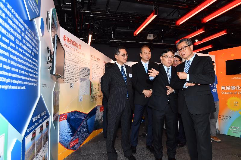 The Financial Secretary, Mr Paul Chan, attended the "Port Works 90 Exhibition - A Time to Remember" opening ceremony today (October 6). Photo shows Mr Chan (first right), accompanied by the Director of Civil Engineering and Development, Mr Lam Sai-hung (second right), and other guests, touring the exhibition.