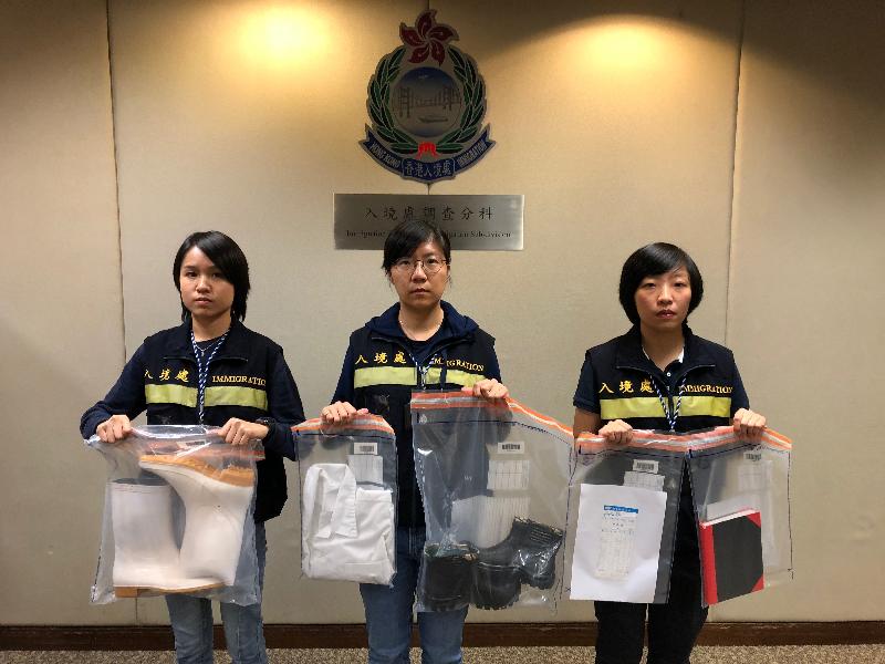 The Immigration Department mounted a joint operation with the Hong Kong Police Force and the Labour Department codenamed "Sahara" yesteday (October 10). Photo shows officers holding items seized during the operation.