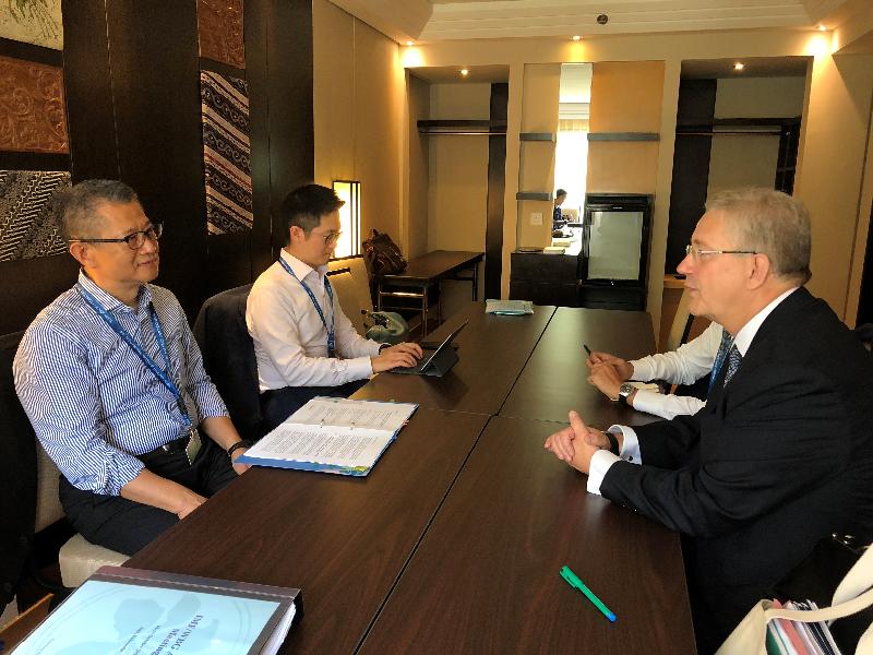 The Financial Secretary, Mr Paul Chan (first left) meets with the Chief Executive of the International Capital Market Association (ICMA), Mr Martin Scheck (first right) today (October 13) in Bali, Indonesia, and they exchange views on the development of green investment and green finance in Hong Kong.