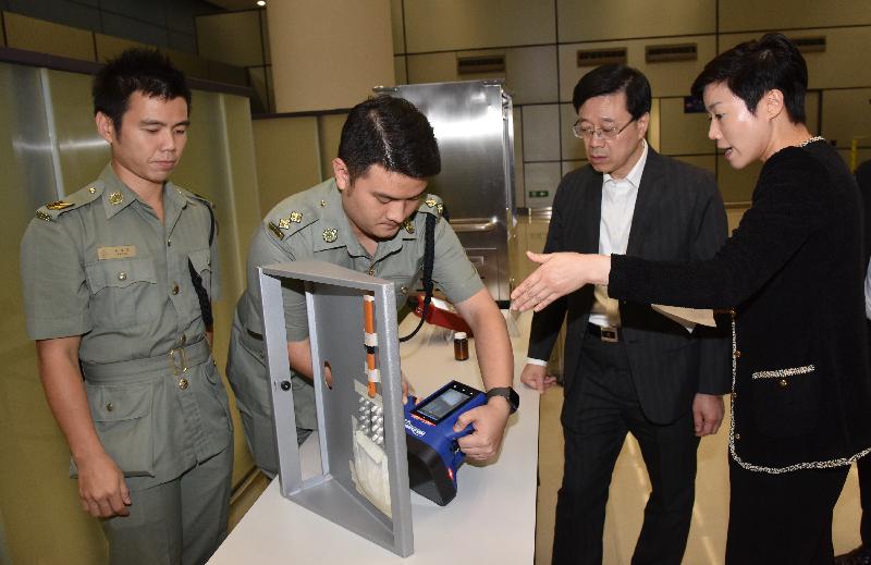 The Secretary for Security, Mr John Lee (second right), toured the Hong Kong-Zhuhai-Macao Bridge Hong Kong Port today (October 24). Photo shows Mr Lee being briefed on the handheld X-ray Imager used for the clearance procedures for passengers by staff of the Customs and Excise Department in the Passenger Clearance Building.   

