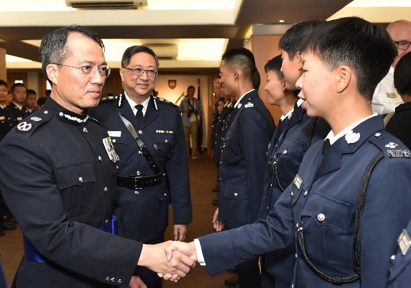 The Commissioner of Police, Mr Lo Wai-chung (second left) and the Deputy Commissioner of Police (Operations), Mr Lau Yip-shing (first left), congratulate the probationary inspectors after the passing-out parade held at the Hong Kong Police College today (November 17).