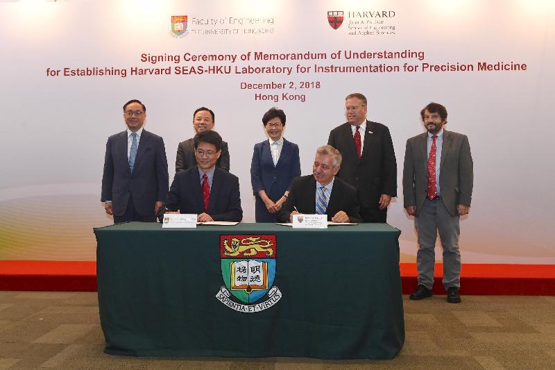 The Chief Executive, Mrs Carrie Lam, witnessed today (December 2) the signing of a Memorandum of Understanding (MoU) to set up a joint laboratory of instrumentation for precision medicine between the Faculty of Engineering at the University of Hong Kong (HKU) and the Harvard John A. Paulson School of Engineering and Applied Sciences (Harvard SEAS). Photo shows (back row, from left) the Secretary for Innovation and Technology, Mr Nicholas W Yang; the President and Vice-Chancellor of HKU, Professor Zhang Xiang; Mrs Lam; the Consul General of the United States to Hong Kong and Macau, Mr Kurt Tong; and the Mallinckrodt Professor of Physics and Applied Physics of Harvard SEAS, Professor David Weitz, witnessing the Dean of Engineering of HKU, Professor Christopher Chao (front row, left), and the Executive Dean for Education and Research of Harvard SEAS, Dr Fawwaz Habbal (front row, right), signing the MoU.