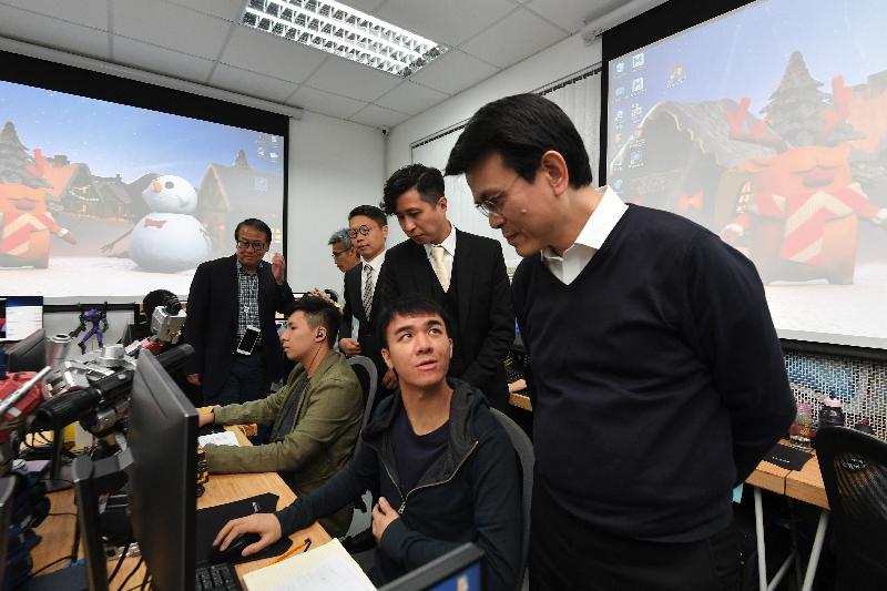 The Secretary for Commerce and Economic Development, Mr Edward Yau, visited the Kam Tin Youth Centre during his visit to Yuen Long District today (December 3). Photo shows Mr Yau (first right) watching a demonstration by students of a computer animation course provided by the vocational training programme Act Plus Animation School.