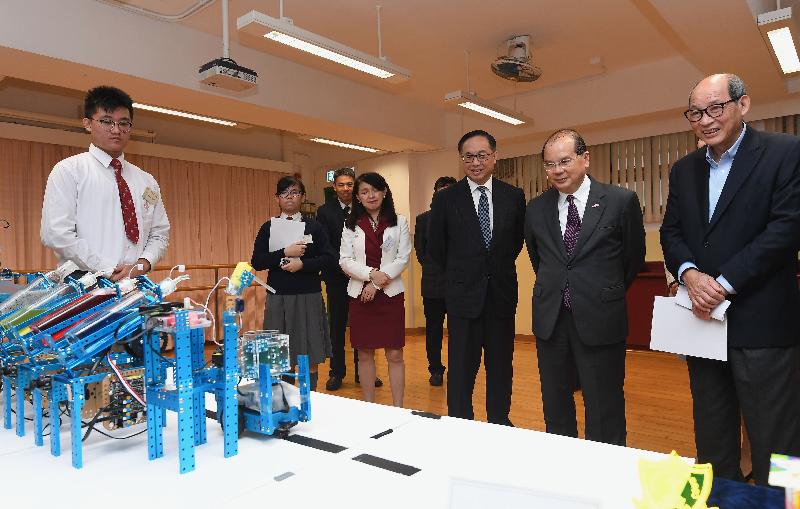 The Chief Secretary for Administration, Mr Matthew Cheung Kin-chung, and the Secretary for Innovation and Technology, Mr Nicholas W Yang, today (December 7) visited Tai Po District and met with students participated in a programme for promotion of science, technology, engineering and mathematics (STEM) education in Tai Po secondary schools. Photo shows Mr Cheung (second right) and Mr Yang (third right) viewing robotic bartender created by students. Also joining is the Chairman of the Tai Po District Council, Mr Cheung Hok-ming (first right). 