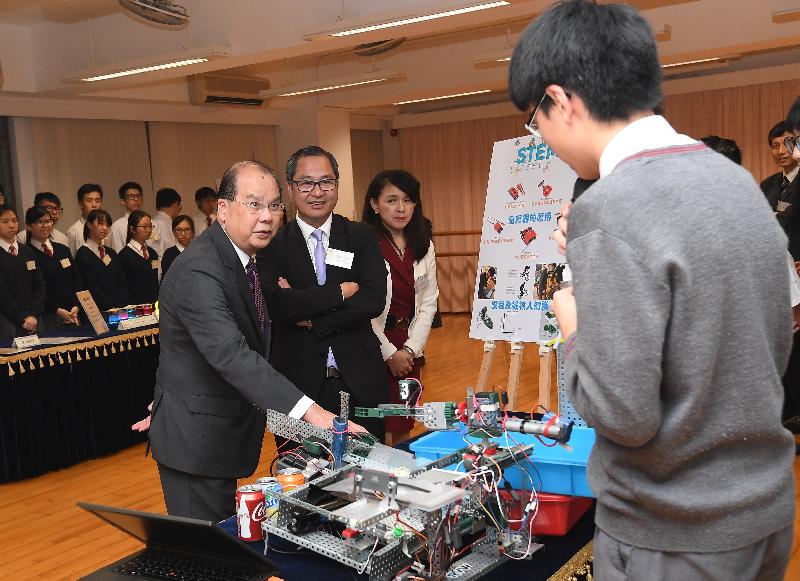 The Chief Secretary for Administration, Mr Matthew Cheung Kin-chung, and the Secretary for Innovation and Technology, Mr Nicholas W Yang, today (December 7) visited Tai Po District and met with students participated in a programme for promotion of science, technology, engineering and mathematics (STEM) education in Tai Po secondary schools. Photo shows Mr Cheung (first left) chatting with a student representative on robotic projects created for the programme.