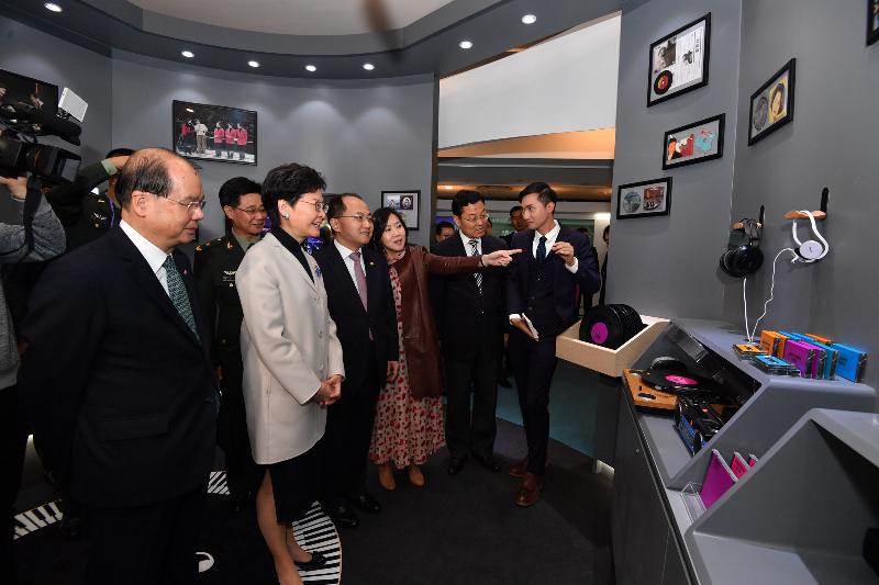 The Chief Executive, Mrs Carrie Lam, toured the HKSARG's Celebration of the 40th Anniversary of the Reform and Opening Up of the Country: 'Joint Development·Shared Prosperity' Exhibition at the Hong Kong Museum of History today (December 11). Photo shows Mrs Lam (fifth right); the Director of the Liaison Office of the Central People's Government in the Hong Kong Special Administrative Region (HKSAR), Mr Wang Zhimin (fourth right); the Commissioner of the Ministry of Foreign Affairs of the People's Republic of China in the HKSAR, Mr Xie Feng (second right); the Deputy Political Commissar of the Chinese People's Liberation Army Hong Kong Garrison, Mr Chen Yading (second left); the Chief Secretary for Administration, Mr Matthew Cheung Kin-chung (first left) and the Director of Information Services, Miss Cathy Chu (third left), touring the music zone where visitors will hear Cantonese pop songs.