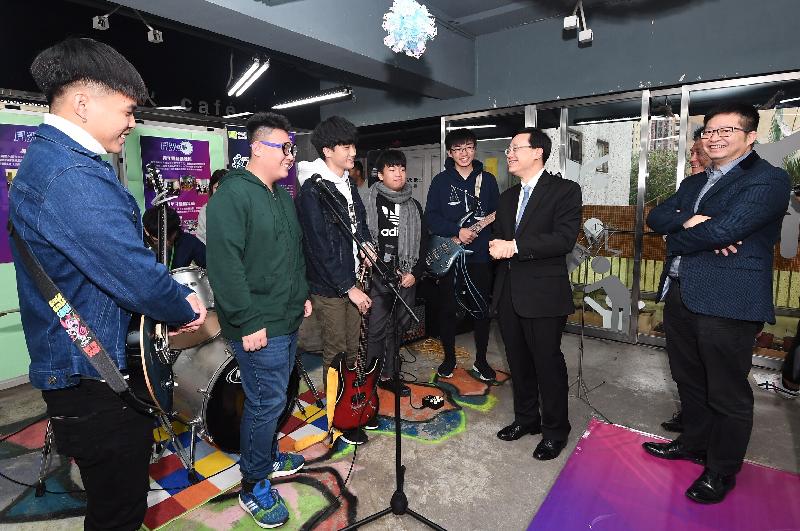 The Secretary for Security, Mr John Lee (sixth left), chats with participants of the Moonlight Project after watching their band performance during his visit to the Jockey Club Tsing Yi Integrated Service Centre for Children and Youth of the Hong Kong Playground Association in Kwai Tsing District this afternoon (December 14).