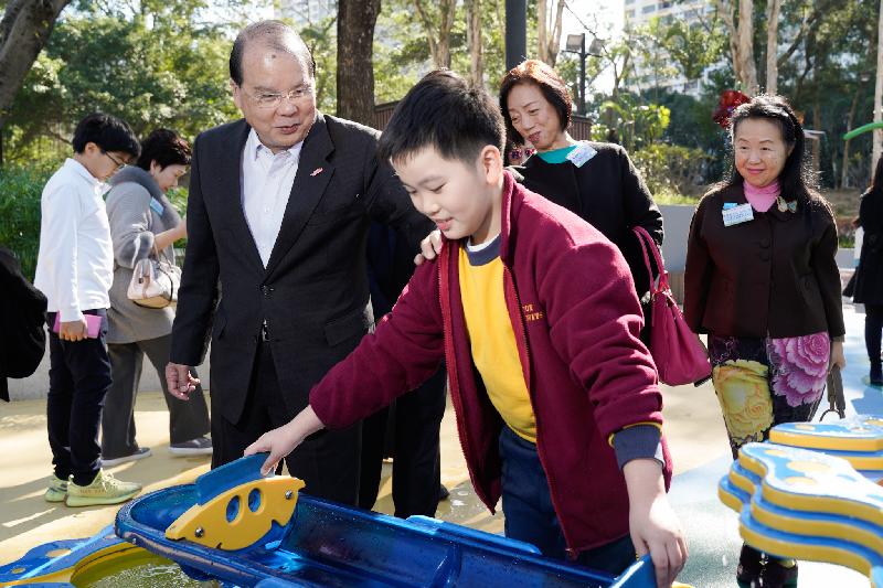 The Chief Secretary for Administration, Mr Matthew Cheung Kin-chung, attended the Tuen Mun Park Inclusive Playground Opening Ceremony today (December 17). Photo shows Mr Cheung (left) touring the facilities in the playground.