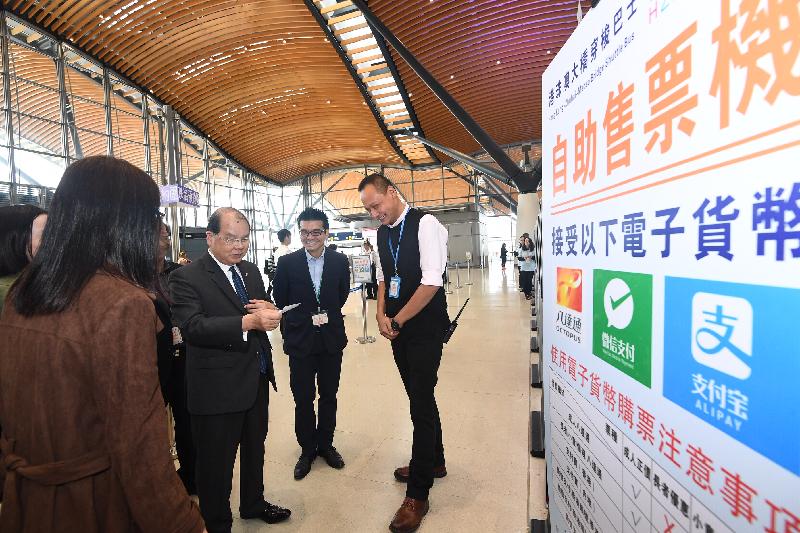 The Chief Secretary for Administration, Mr Matthew Cheung Kin-chung (third right), today (December 19) visits the Hong Kong Port of the Hong Kong-Zhuhai-Macao Bridge and learns about the ticketing of the cross-boundary coaches at Passenger Clearance Building. 
