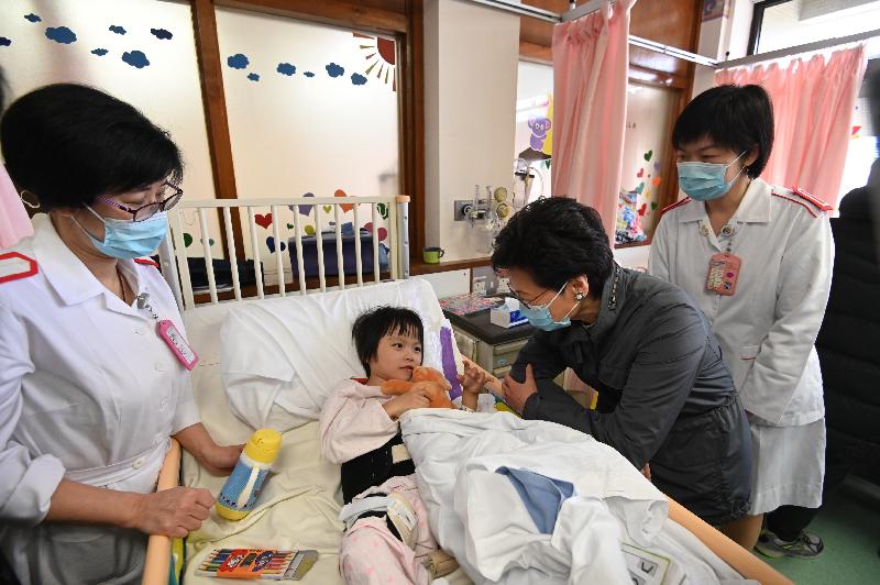 The Chief Executive, Mrs Carrie Lam (second right), this morning (January 1) visited Tuen Mun Hospital to learn about various measures that the Hospital Authority had put in place during the winter surge of influenza and extend New Year greetings to the healthcare workers and patients. Photo shows Mrs Lam visiting a patient at the Paediatrics and Adolescent Medicine ward.