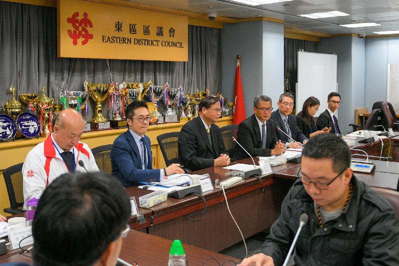 The Financial Secretary, Mr Paul Chan (back row, fourth left), accompanied by the District Officer (Eastern), Mr Simon Chan (back row, third right), visits the Eastern District Council (EDC) today (January 11) and meets with the Chairman of the EDC, Mr Wong Kin-pan (back row, third left), and members of the EDC to exchange views on various livelihood and development issues.

