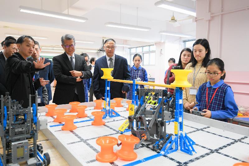 The Financial Secretary, Mr Paul Chan, visited Aldrich Bay Government Primary School in Eastern District this afternoon (January 11). Photo shows Mr Chan (fourth left) viewing school projects related to STEM (science, technology, engineering and mathematics).
