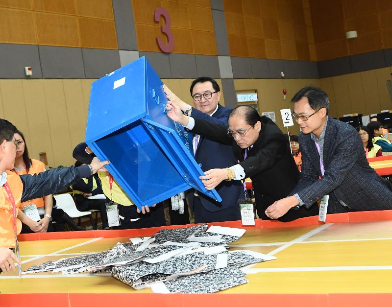 The Chairman of the Electoral Affairs Commission (EAC), Mr Justice Barnabas Fung Wah (third right), empties a ballot box at the counting station at Cheung Chau Sports Centre for the 2019 Kaifong Representative Election today (January 20). Also present is EAC member Mr Arthur Luk, SC (second right).