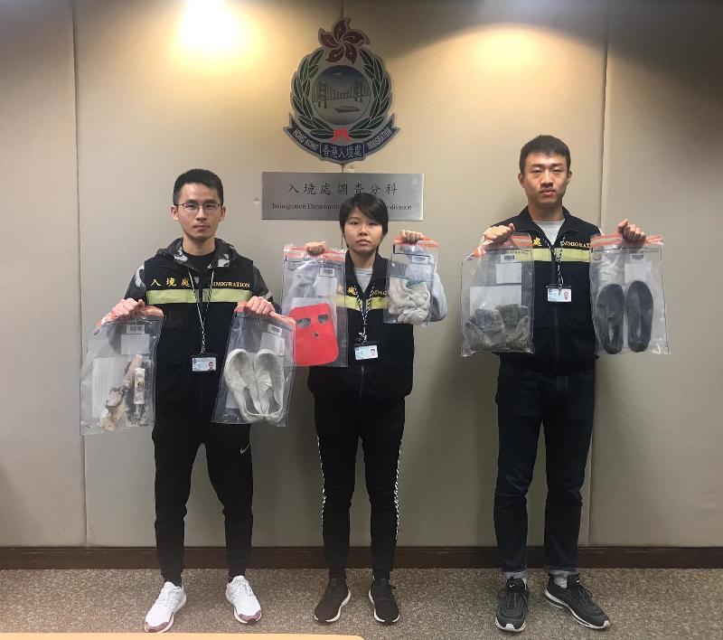 The Immigration Department mounted a territory-wide anti-illegal worker operation codenamed "Twilight" from January 21 to 23. Photo shows officers holding items seized during the operation.