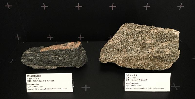 香 港 联 合 国 教 科 文 组 织 世 界 地 质 公 园 游 客 中 心 已 完 成 翻 新 工 程 ， 将 于 二 月 七 日 重 新 开 放 ， 透 过 全 新 的 展 品 呈 现 香 港 的 地 质 故 事 。 图 示 全 球 已 知 最 古 老 的 岩 石 － － 阿 卡 斯 塔 片 麻 岩 的 碎 块 （ 左 ） 和 中 国 已 知 最 古 老 的 岩 石 之 一 － － 白 家 坟 片 麻 岩 的 碎 块 （ 右 ） 。 