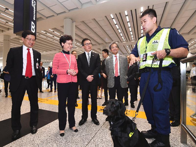 The Chief Executive, Mrs Carrie Lam, attended the Chinese New Year festive activities at Hong Kong International Airport today (February 5). Photo shows Mrs Lam (second left), accompanied by the Commissioner of Customs and Excise, Mr Hermes Tang (third left), visiting front-line officers of the Customs and Excise Department on duty at the airport to learn about their work. 
