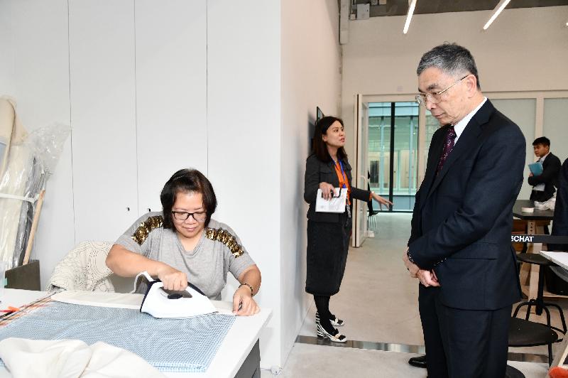 The Secretary for Financial Services and the Treasury, Mr James Lau (right), visits the Centre for Heritage, Arts and Textile today (February 15) to learn about how it promotes the culture and art of textiles.