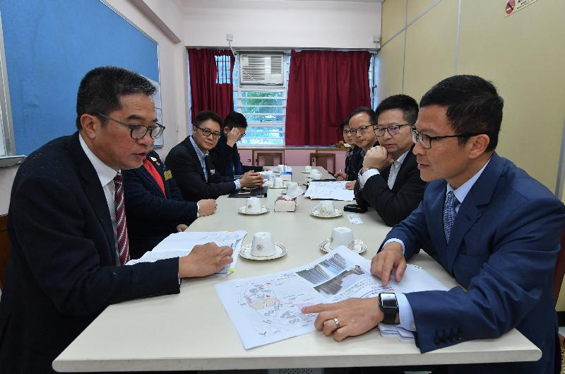 The Secretary for Development, Mr Michael Wong, visited Kwai Tsing District today (February 18) to learn more about the latest developments and needs of the community. Photo shows Mr Wong (first left) being briefed by the District Officer (Kwai Tsing), Mr Kenneth Cheng (right), on the proposed future planning and development plan for Ching Hong Road North and its adjoining areas. Looking on is the Chairman of the Kwai Tsing District Council, Mr Law King-shing (second right). 