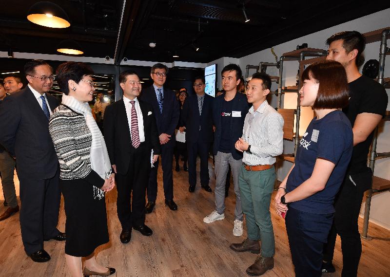 The Chief Executive, Mrs Carrie Lam, visited Smart-Space 8, a co-working space operated by Cyberport in Tsuen Wan District this afternoon (February 22). Photos shows Mrs Lam (second left) chatting with young start-up entrepreneurs. Also present are the Secretary for Innovation and Technology, Mr Nicholas W Yang (first left), the Chairman of Hong Kong Cyberport Management Company Limited, Dr George Lam (third left), and the Chief Executive Officer of the Hong Kong Cyberport Management Company Limited, Mr Peter Yan (fourth left).
