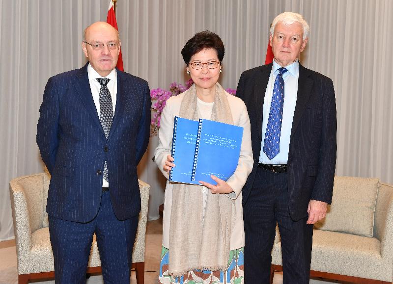 The Chief Executive, Mrs Carrie Lam (centre), receives an interim report today (February 25) from the Chairman and Commissioner of the Commission of Inquiry (the Commission) into the Construction Works at and near the Hung Hom Station Extension under the Shatin to Central Link Project, Mr Michael Hartmann (right), who is accompanied by the Commissioner of the Commission, Professor Peter Hansford (left).