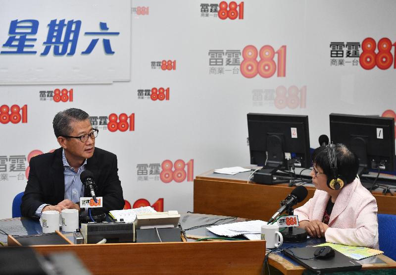 The Financial Secretary, Mr Paul Chan (left), attends the Commercial Radio programme "Saturday Forum" this morning (March 2) to answer questions on the 2019-20 Budget.