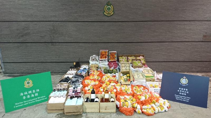 Hong Kong Customs and the Marine Police today (March 4) conducted an anti-smuggling joint-operation and detected two suspected smuggling cases using fishing vessels in the waters of Lau Fau Shan.  A large batch of suspected smuggled goods including vehicle parts, cosmetics, wines and fruits with an estimated market value of about $550,000 were seized. 