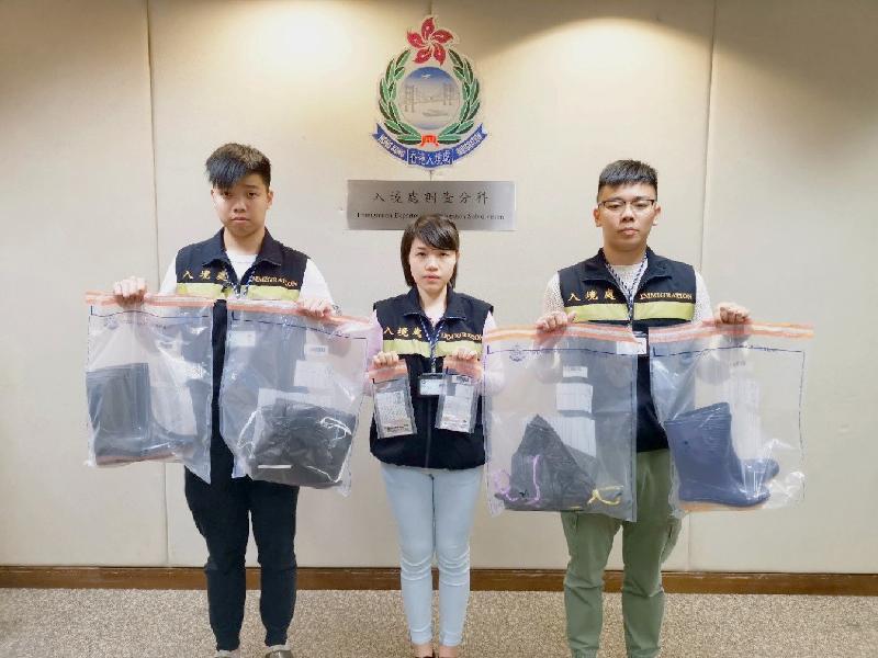 The Immigration Department mounted a territory-wide anti-illegal worker operation codenamed "Twilight" from March 4 to 7. Photo shows officers holding items seized during the operation.