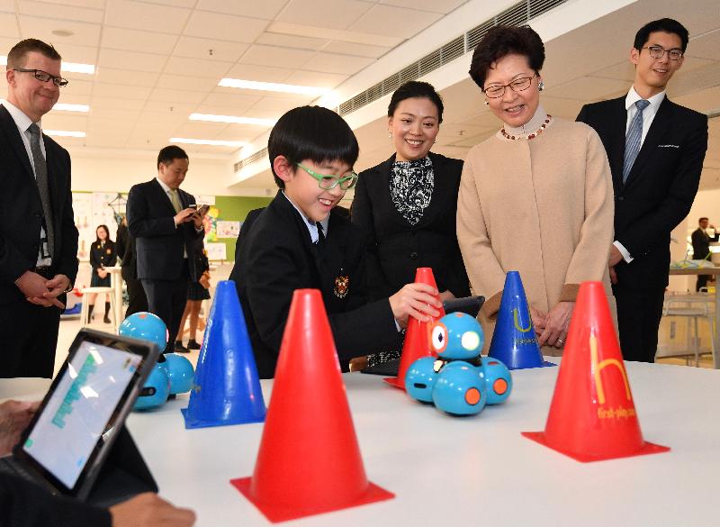 The Chief Executive, Mrs Carrie Lam, attended the opening ceremony of Malvern College Hong Kong today (March 11). Photo shows Mrs Lam (second right) listening as a student explains the making of a robot. 
