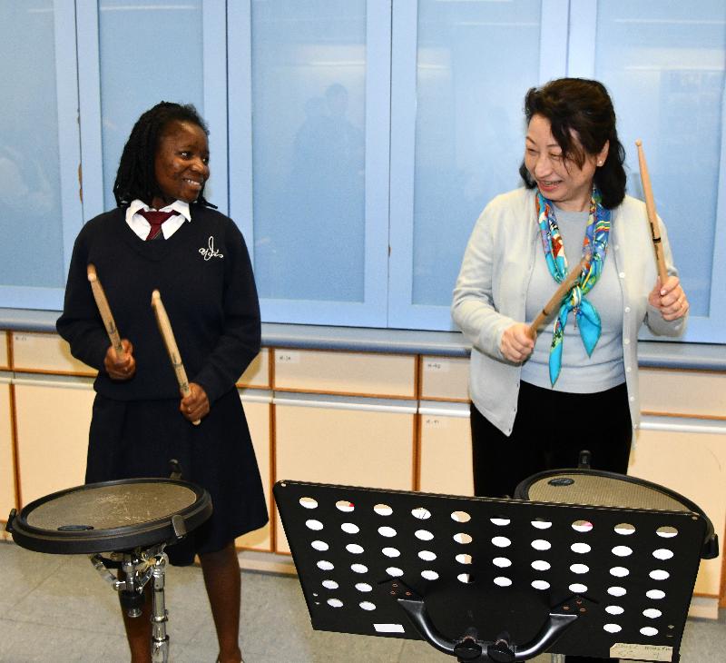 The Secretary for Justice, Ms Teresa Cheng, SC, visits Caritas Wu Cheng-chung Secondary School in Pokfulam today (March 12). Photo shows Ms Cheng (right) joining a student in music class.
